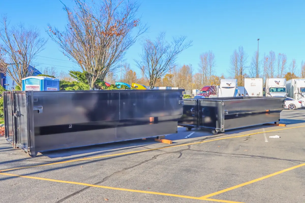 Professional dumpster rental service with roll-off container on residential driveway in Todd Creek